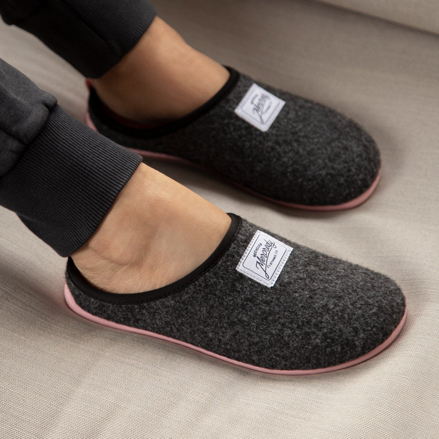 Women's Mercredy Wool Slippers with a Rubber Sole, made from Recycled Plastic Bottles, Black upper & Pink sole.